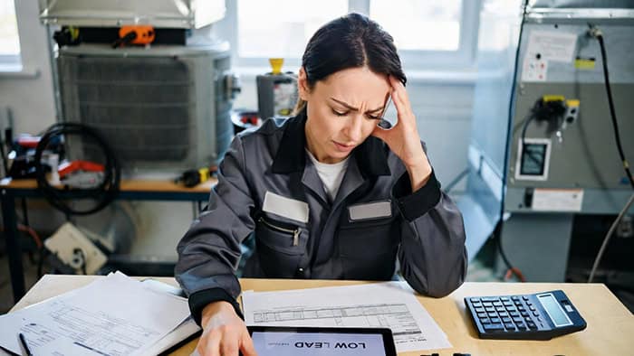Frustrated HVAC contractor reviewing online reviews and reputation management challenges in Colorado Springs.